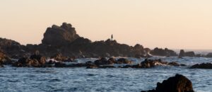 Person on rocky shoreline, Ucluelet BC