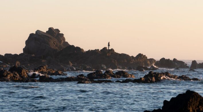 Person on rocky shoreline, Ucluelet BC